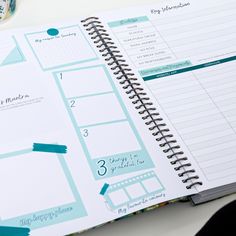 an open planner book sitting on top of a table