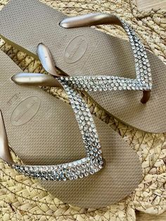 Havaianas with clear crystals on the straps. I always use the wider strap flip flops, these are called TOP by Havaianas they have 4 rows of gorgeous crystals on them. If you prefer AB sparkle crystals see my other listing. Made to order with crystal rhinestones and Havaianas in your choice of size and colour. Message me with any special requests, sizes, colours and crystals can be created to whatever you desire. I keep most sizes in stock in black and white but I I am happy to order in any colou Cheap Silver Party Flip Flops, Party Gold Flip Flops With Rhinestones, Gold Rhinestone Party Flip Flops, Luxury Flip Flops With Single Toe Strap, Elegant Gold Flip Flops With Rhinestones, Cheap Rhinestone Flip Flops For Beach, Silver Rhinestone Party Flip Flops, Silver Open Toe Flip Flops With Rhinestones, Flat Rhinestone Flip Flops For Beach