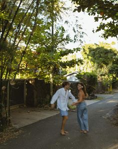 a man and woman are walking down the street