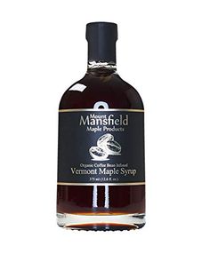 a bottle of vermont maple syrup on a white background