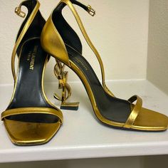 Ysl Logo Gold Heels! These Have Been So Popular Over The Years. Ive Worn It Few Times So You Can See Wear On It. Just Very Minimal Peeling (On Front Of Shoe And Side). Please Refer To Photos For Condition! Size 35 1/2 ! Its The Real Shoe. Beautiful Look, Again Worn A Few Times But Decent Condition! Ysl Heels, Yves Saint Laurent Shoes, Ysl Logo, Saint Laurent Shoes, Gold Heels, Shoes Women Heels, Over The Years, Yves Saint Laurent, Saint Laurent