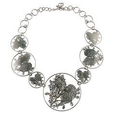 CHRISTIAN LACROIX vintage silver toned necklace featuring seven laser cut stylized heart medallions and crystal embellishement. Silver tone metal hardware. Monogram CL signature on each medallion (see example on the last picture). T-bar closure. Indicative measurements : total length approx. 56.5 cm (22.24 inches) / diameter of the central medallion 6.8 cm (2.68 inches). NOTES - This is a preloved vintage item, therefore it might have imperfections. - Colors may differ slightly from actual produ Medallion Necklace, Christian Lacroix, Link Necklace, Metal Hardware, Vintage Silver, Laser Cut, Yves Saint Laurent, Metallica, Saint Laurent