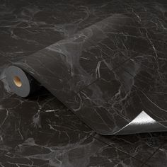 a roll of black marble paper on the ground