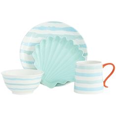 a blue and white striped dishware set with an orange handled spoon, cup and saucer