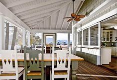 a dining room table with chairs and a ceiling fan