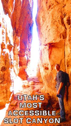 a man standing in the middle of a narrow canyon