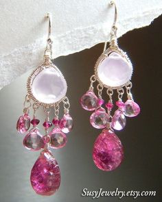 If you love the color pink like I do--you want these lovelies! These exquisite pink gemstone chandelier earrings feature sterling silver wire wrapped frames with large rose quartz drops, lovely pink topaz, and large deep fuchsia pink tourmaline teardrop beads. If that wasn't enough pink, tiny faceted deep pink tourmaline beads accent each earring as a final touch. Sterling silver ear wires complete the set. Beautiful, feminine, delicate and so very special....just like you! Details Handmade item Tourmaline Quartz, Pink Gem, Sterling Silver Wire Wrap, Pink Topaz, Tourmaline Beads, Wire Wrapped Earrings, Teardrop Beads, Pink Gemstones, Pretty Earrings