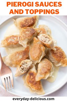 a white plate topped with dumplings next to a fork