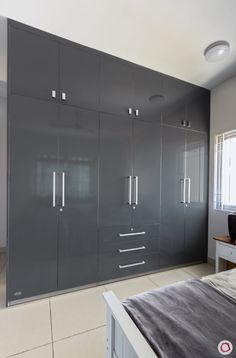 a bedroom with gray cabinets and white floors