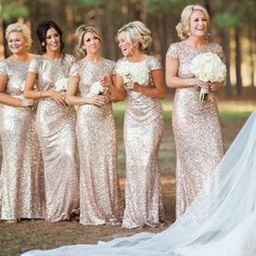 the bride and her bridesmaids in gold sequin gowns for their wedding