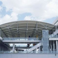 the inside of an airport terminal with stairs leading up to it's roof area