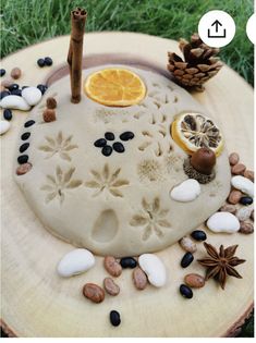 an orange slice is sitting on top of some rocks and stones in the shape of a snowflake