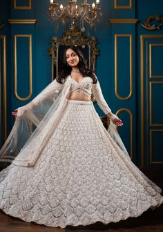 Item: Lehenga Set ( Lehenga Skirt, Blouse and Dupatta) Step into modern royalty with our Enchanting Magnolia Bridal Lehenga. Expertly crafted by our artisans, this ensemble is a perfect blend of tradition and contemporary design. Each embellishment is intricately placed, showcasing the sheer hard work and dedication that goes into every detail. Let us customize your lehenga to reflect your unique style and make your wedding day truly unforgettable. This bespoke lehenga curated with love and care Traditional Gown With Cutdana For Ceremony, Traditional Ceremony Gown With Cutdana, Elegant Anarkali Set With Traditional Drape For Ceremony, Traditional Drape Lehenga With Cutdana For Ceremony, Anarkali Sharara With Cutdana For Ceremonies, Elegant Fitted Sharara For Ceremony, Intricate Embroidered Gown For Diwali Ceremony, Elegant Choli For Ceremony With Traditional Drape, Elegant Saree Sets For Ceremony