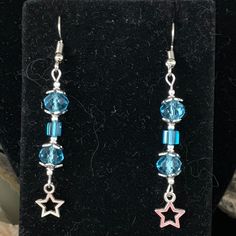 Pretty little blue  swarovski crystals make up this pair of earrings. Add a tiny star and wala! Nice gift for Mother's Day or any birthday/anniversary/Christmas. Got a Q? drop me a note! Enjoy! peace Blue Star Charm Earrings For Gift, Blue Star Charm Earrings As Gift, Blue Hypoallergenic Crystal Earrings As Gift, Blue Hypoallergenic Crystal Earrings For Gift, Hypoallergenic Blue Crystal Earrings For Gift, Hypoallergenic Blue Star Earrings, Star-shaped Crystal Earrings For Gifts, Silver Star Charm Crystal Earrings For Gift, Blue Dangle Earrings For Birthday