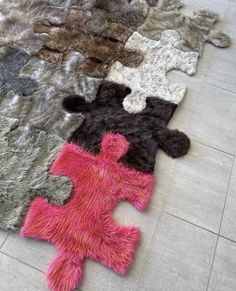 the rugs are all different colors and patterns on the floor, but one is made out of fake fur