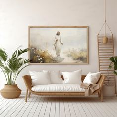 a living room with white furniture and paintings on the wall