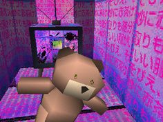 a teddy bear is standing in front of a computer screen with letters all over it