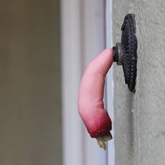 a pink object sticking out of the side of a building