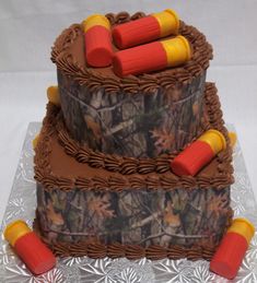 two tiered camouflage cake with orange and yellow decorations