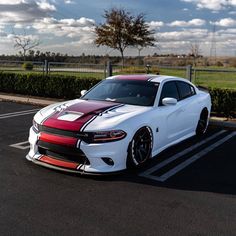 a white and red car parked in a parking lot