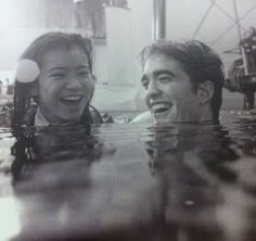 two people are laughing in the water