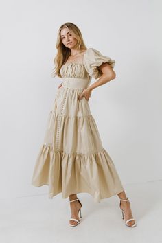 This beige hue maxi dress with puff sleeves is perfect for a formal event or special occasion! The corset-style bodice and front slit add a touch of glamour, while the comfortable fabric makes it easy to wear. Ruched bust Puff sleeve Fake cover buttons Front slit Maxi length Partial back smocking Side zipper Partial lining Shell: 100% Cotton Lining: 80% Polyester 20% Cotton Style# HN636D Size on Model: XS Measurements from size XS: Total length: 53", Bust: 32" Summer Long Dresses, Corset Maxi Dress, Cotton Maxi Dress, Cotton Maxi, Corset Style, Nordstrom Dresses, Cotton Style, Chiffon Tops