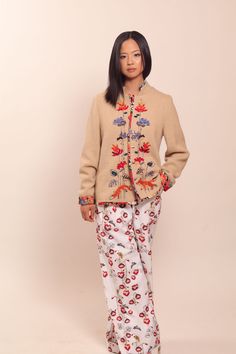 "Beige wool jacket with floral embroidery and natural silk lining. Embellished with Swarovski crystals. Each jacket is hand embroidered and one of a kind. Collection \"MOON [mo:n]\" is inspired by floral embroidery from Muhu, a small island in Estonia with great handicraft traditions.  Each flower, bird and animal embroidered on the jacket has their own symbolic meaning. This jacket will be made especially for you and according to your measurements. Please allow 2-4  weeks for creating it. We sh Traditional Embellished Spring Outerwear, Traditional Silk Outerwear For Spring, Embellished Long Sleeve Silk Outerwear, Embroidered Long Sleeve Silk Outerwear, Silk Outerwear With Intricate Embroidery For Spring, Spring Embroidered Wool Cardigan, Spring Wool Cardigan With Embroidery, Spring Wool Outerwear With Embroidery, Embroidered Wool Outerwear For Fall