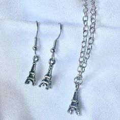 "One of our shop members made an earring and necklace out of these cute vintage style Eiffel Tower souvenir charms. Perfect for your favorite Parisienne (or Paris fan)!  These charms are petite so this is also a great gift for little ladies. Components: Eiffel Tower charms, wire hooks*, chain necklace  Dimensions: 18\" long necklace, charms are 5/8\" long Condition: New  These sets are available in bronze, silver and copper- all have an antiqued finish.  I'm happy to ship internationally- just m Cute Nickel-free Metal Charm Necklace, Cute Nickel-free Metal Charm Necklaces, Cute Metal Charm Necklace Nickel Free, Cute Nickel-free Pendant Jewelry, Silver Vintage Charm Earrings For Gift, Silver Earrings With Vintage Charm As Gift, Silver Earrings With Vintage Charm For Gift, Vintage Hypoallergenic Jewelry For Gift, Hypoallergenic Vintage Jewelry For Gift