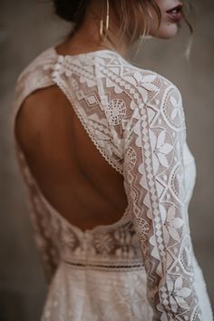 a woman wearing a white dress with open back