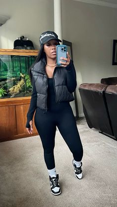 Black outfit idea! This seamless ribbed black jumpsuit has been going viral on Tiktok. It sucks you in and shows your curves! I sized up and got a medium. I love how it fits. I styled it with a black puffer vest, white socks, black hat, and panda dunk high. #athleisure #athleisurestyle #athleisureoutfits Follow my shop @Juscallmenicki on the @shop.LTK app to shop this post and get my exclusive app-only content! #liketkit #LTKfindsunder50 #LTKshoecrush #LTKstyletip @shop.ltk Styling Panda Dunks Women, Jumpsuit Outfit Black Women Sneakers, Fits With Puffer Vest, 1s Outfit Black Women, Black Jumpsuit With Puffer Vest, Winter Nba Game Outfit, Sneaker Socks Outfit, Fall Outfits With Panda Dunks, Black Crop Jacket Outfit