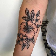 a black and white flower tattoo on the arm