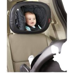 a baby in a car seat looking at the camera