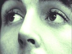 a close up of a person's face with long eyelashes