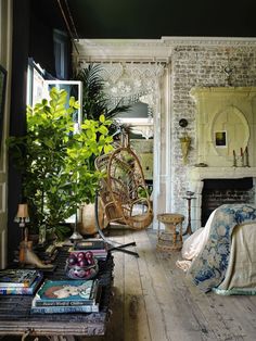 a bedroom with a bed, wicker chair and plants on the floor next to it