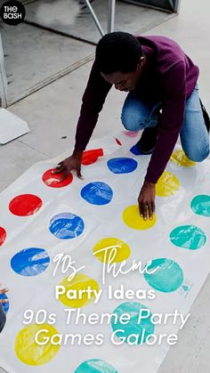 two children are painting on a large white board with colorful circles and the words, my theme party ideas 90's theme party games galore