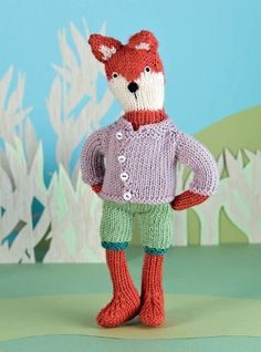 a knitted fox wearing a sweater and pants