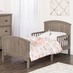 a bedroom with a bed, dresser and two night stands