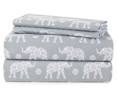 three sheets with elephants on them in grey and white colors, one has an elephant print