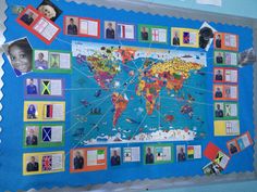 a blue bulletin board with pictures of people around the world on it and some flags