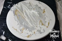 a white plate with gold paint on it