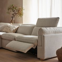 a living room with a sectional couch and pillows