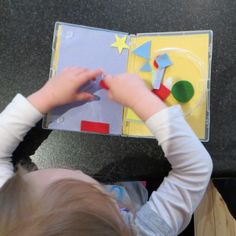 a young child is playing with construction paper