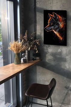 a chair sitting in front of a window next to a table with flowers on it