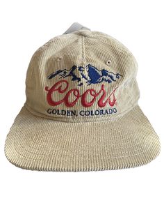 Show off your love for Coors Beer with this cool corduroy snapback hat from Mad Engine. This cap features the iconic Coors logo and is perfect for both casual wear and travel. The hat is made of lightweight and breathable cotton fabric, which makes it suitable for all seasons. The adjustable snapback design ensures a comfortable fit for all head sizes. This hat is perfect for those who love the outdoors and enjoy activities like fishing, camping, and beer drinking. Add this hat to your collectio Trendy Corduroy Snapback Baseball Cap, Vintage Corduroy Flat Brim Baseball Cap, Casual Corduroy Snapback Baseball Cap, Casual Corduroy Snapback Hat For Streetwear, Casual Adjustable Corduroy Trucker Hat, Casual Corduroy Baseball Cap For Streetwear, Casual Corduroy Dad Hat With Flat Bill, Casual Corduroy 5-panel Baseball Cap, Vintage Corduroy Snapback Trucker Hat