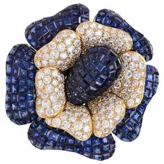 This outstanding Collectable flower brooch pin was designed by Sabbadini, Italy. It is handcrafted in solid 18K yellow gold weighing approx. 69.9 grams. It features a flowerhead design of bombé calibrated step-cut high quality royal blue genuine sapphires petals (in invisible mystery setting which was originally developed by Van Cleef and Arpels) all approx. 46.00 carats and Approx. 9.00 carats of diamonds, White H color, Very Clean VS Clarity. With an openwork back this enchanting brooch pin is Diamond Flower Brooch, Van Cleef And Arpels, Antique Pendant, Antique Brooches, Diamond Brooch, Mom Jewelry, Gold Brooches, Pearl Brooch, Diamond Flower