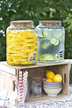 two mason jars filled with lemonade and cucumbers