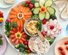 a platter filled with vegetables and dip