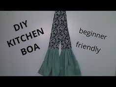 there is a sign that says diy kitchen boa and has two ruffles hanging from it