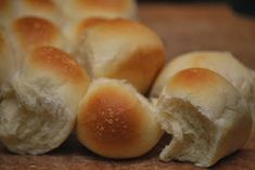 several bread rolls sitting on top of a cutting board