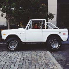 an old white pickup truck parked on the street